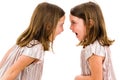 Identical twin girls sisters are arguing yelling at each other Royalty Free Stock Photo