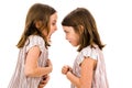 Identical twin girls sisters are arguing yelling at each other Royalty Free Stock Photo