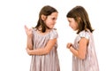 Identical twin girls sisters are arguing yelling at each other Royalty Free Stock Photo