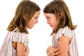 Identical twin girls sisters are arguing yelling at each other