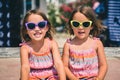 Identical twin girls on summer vacation posing for camera. Royalty Free Stock Photo