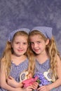 Identical twin sisters holding Royalty Free Stock Photo