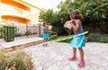 Identical twin sisters are playing on vacation with hula hoop Royalty Free Stock Photo