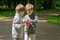 Identical twins with popcorn in the park