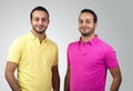 Identical twins portraits shot against white background Royalty Free Stock Photo