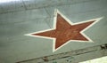Identification mark of the Air Force of the Russian Federation, a five-pointed red star, bordered by a white stripe on an old Royalty Free Stock Photo