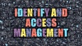 Identify and Access Management on Dark Brick Wall.