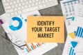 Identify Your Target Market is written in a document on the office desk