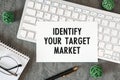 Identify Your Target Market is written in a document on the office desk