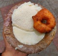 Idili wada and chutney served in a traditional leaf plate.