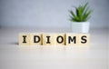 Idioms word concept on cubes, jargon concept. Royalty Free Stock Photo