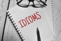 IDIOMS wording with spectacles and pen