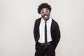 Idiotic afro man in white glasses grimacing at camera. Royalty Free Stock Photo