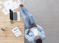 Careless worker using smartphone and keeping his legs on table Royalty Free Stock Photo