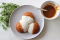 Idli half covered with podi chutney also named as gunpowder. Podi is made of ground pulses, dried red chillies and pepper