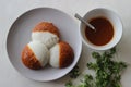 Idli half covered with podi chutney also named as gunpowder. Podi is made of ground pulses, dried red chillies and pepper