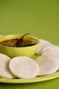 Idli with Sambar in bowl on green background, Indian Dish Royalty Free Stock Photo