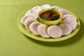 Idli with Sambar in bowl on green background, Indian Dish Royalty Free Stock Photo