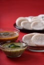 Idli with Sambar in bowl on red background, Indian Dish Royalty Free Stock Photo