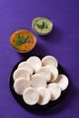 Idli with Sambar and coconut chutney on violet background, Indian Dish Royalty Free Stock Photo