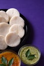 Idli with Sambar and coconut chutney on violet background, Indian Dish Royalty Free Stock Photo