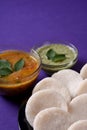 Idli with Sambar and coconut chutney on violet background, Indian Dish Royalty Free Stock Photo