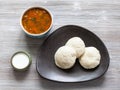 Idli Sambar steamed dumplings with sauses on table