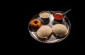 Idli vada with sambhar and chutney a famous south Indian breakfast dish isolated on black background Royalty Free Stock Photo