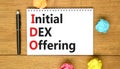IDO initial DEX offering symbol. Concept words IDO initial DEX offering on beautiful white note. Beautiful wooden table wooden Royalty Free Stock Photo