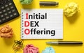 IDO initial DEX offering symbol. Concept words IDO initial DEX offering on beautiful white note. Beautiful yellow background.