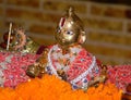 Idol of cute Baby Krishna with silk clothes and ornaments