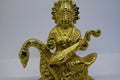 Idol of Goddess Devi Saraswati made of brass, isolated on a white background. Close up