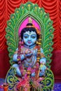 Idol of Goddess Laddu Gopal or little Lord Krishna at a decorated puja pandal in Kolkata