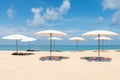 Idollic beach relaxing concept with white parasols on sand Royalty Free Stock Photo