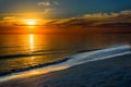 Beautiful dark orange idyllic sunset by the ocean