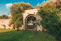 Old arc gateway in a garden in Italy