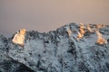 Idyllic alpine snowy mountain chain peak view in orange sunset sky, julian alps, Slovenia Royalty Free Stock Photo