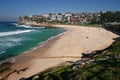 Idyllic and amazing seaside landscape of beach with white rushing sea waves, and hillside buildings in Sydney, Australia