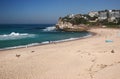 Idyllic and amazing seaside landscape of beach with white rushing sea waves, and hillside buildings in Sydney, Australia