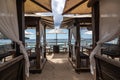 Idyllic beach restaurant with wooden tables and benches and white umbrellas Royalty Free Stock Photo