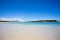 Beach scene with clear blue water, blue sky and sandy shore seen from Puerto Rico