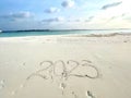 Idyllic beach scene featuring the number 2023 written in the sand, Maldives