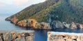 Idyllic coast of Balearic island Ibiza with steep cliffs and overgrown hills