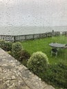 Idyllic coastal landscape Swanage in Dorset and cliff view through a window with drops on glass, part of the Jurassic coast in Dor Royalty Free Stock Photo