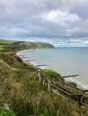 Idyllic coastal landscape Swanage in Dorset and cliff view through a window with drops on glass, part of the Jurassic coast in Dor Royalty Free Stock Photo