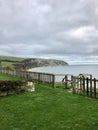 Idyllic coastal landscape Swanage in Dorset and cliff view through a window with drops on glass, part of the Jurassic coast in Dor Royalty Free Stock Photo