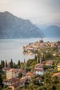 Idyllic coastline in Italy: Blue water and a cute village at lago di garda, Malcesine, sunset Royalty Free Stock Photo