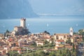 Idyllic coastline scenery in Italy: Blue water and a cute village at lago di garda, Malcesine Royalty Free Stock Photo