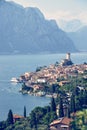 Idyllic coastline scenery in Italy: Blue water and a cute village at lago di garda, Malcesine Royalty Free Stock Photo