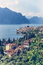 Idyllic coastline scenery in Italy: Blue water and a cute village at lago di garda, Malcesine Royalty Free Stock Photo